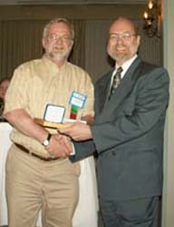 Laurence Duncan, on behalf of James R. Bakes receiving the Guy Potter Literary Award for the best article in The CN Journal from Tim Henderson